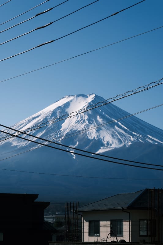 Snow-Capped Peak Beyond Urban Wires